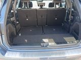 the back of a car with its trunk open and seats folded down