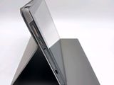 a close up of a laptop on a white surface
