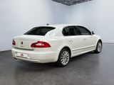 the back of a white volkswagen passat parked in a room