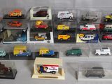 many different types of toy cars in a display case