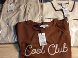 three shirts that are sitting on a wooden table