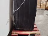 a black trash can sitting on a pallet in a warehouse