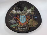 a black plate with a picture of a city on it