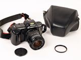 a black camera and a black case on a white surface