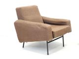 a brown chair that is sitting on a black metal frame