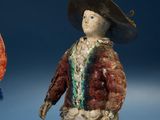 two figurines of a man and a woman with hats on