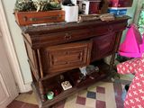 a wooden dresser with a mirror on top of it