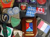 many different types of badges on a black cloth