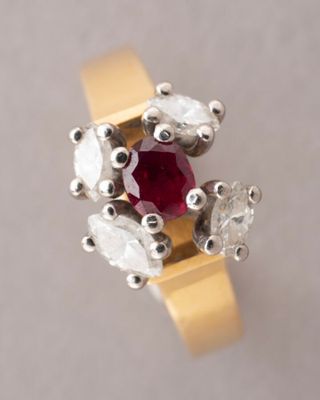 an image of a close up of a ring with a red stone