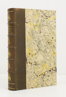 an old book sitting on top of a white table next to a white wall