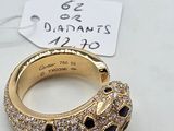 an image of a gold ring with black and white stones on it