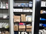 many boxes and containers on the shelves in the room