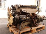 a very old engine on a pallet on the street