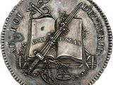 a close up of a coin with a sword and a book on it