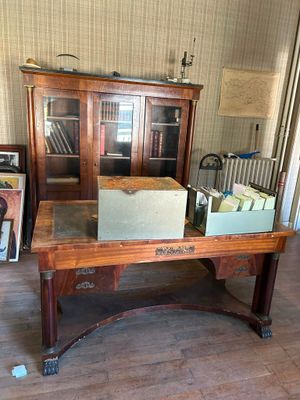 a desk with a lot of books on it in a room