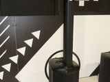 a black stove sitting next to two speakers in a room