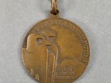 a close up of a medal with a bird on it