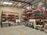 a large warehouse filled with lots of shelves and pallets