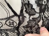 a close up of a person ' s hand holding a piece of lace