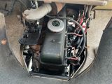 a small engine in the back of an old car