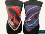 pair of mannequins with multicolored scarves on them