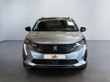 the front view of a silver car in a showroom
