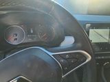a steering wheel and dashboard of a car with a clock on it