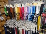 many different colored ties hanging on a rack in a store