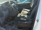 the interior of a car with the door open and the driver ' s seat down