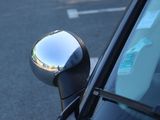 a close up of a car ' s side mirror on the side of the road