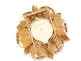 an image of a close up of a gold colored flower brooch
