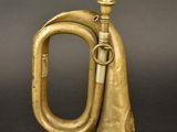 an old brass trumpet sitting on top of a black table