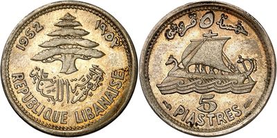 a close up of a coin with a ship on it