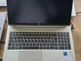 two laptops sitting on a table next to each other