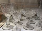 many wine glasses lined up on a table