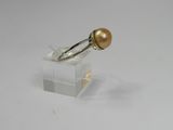 an image of a gold pearl ring on a clear acrylic stand