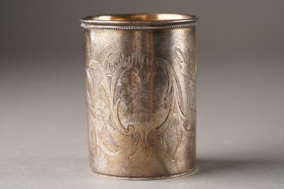 a silver cup with a design on it on a table