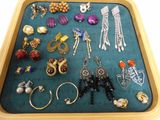 a tray that has many different types of jewelry on it