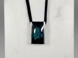 a necklace with a green stone on a black cord
