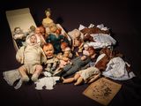 a lot of dolls that are sitting on a table
