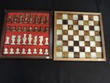 two chess pieces in a wooden box on a black surface