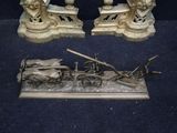 two statues of a man and a woman on a horse drawn carriage
