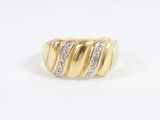 a close up of a gold and diamond ring on a white background