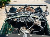 a view of the dashboard and steering wheel of a vintage car