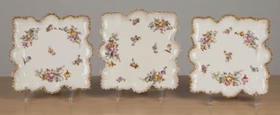 three plates that have been decorated with flowers on them