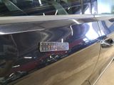 a close up of a car door handle with a sticker on it