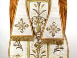 an image of a white vest with gold trimmings on it