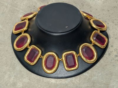 an image of a necklace with red stones on it