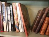 many books that are on a book shelf together