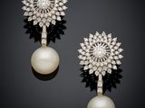 a pair of pearl and diamond earrings